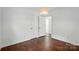 Bedroom with hardwood floors, a window, and bathroom access at 6558 Covecreek Dr, Charlotte, NC 28215
