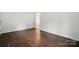 A bedroom with hardwood floors and white walls provides a clean and inviting space at 6558 Covecreek Dr, Charlotte, NC 28215