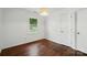 Bedroom with hardwood floors, a window, and a built in light at 6558 Covecreek Dr, Charlotte, NC 28215