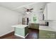 Open-concept kitchen design with stainless appliances, white cabinetry, and center island at 6558 Covecreek Dr, Charlotte, NC 28215