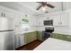 Well-lit kitchen with stainless steel appliances, white subway tile, and hardwood floors at 6558 Covecreek Dr, Charlotte, NC 28215