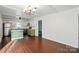 An updated kitchen includes a kitchen island, stainless steel refrigerator, and tile backsplash at 6558 Covecreek Dr, Charlotte, NC 28215
