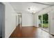 A well lit living room features hardwood floors and access to the backyard at 6558 Covecreek Dr, Charlotte, NC 28215