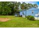 Backyard featuring a blue home with green grass and trees at 7041 Kays Dr, York, SC 29745