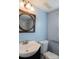 Bathroom featuring a round mirror, single sink, and a shower-tub combination at 7041 Kays Dr, York, SC 29745