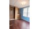 Bedroom with wood paneled walls, a closet, and hardwood floors at 7041 Kays Dr, York, SC 29745