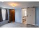 Bedroom featuring modern sliding door to ensuite bathroom, carpeted floors, and natural light at 7041 Kays Dr, York, SC 29745