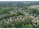 Expansive aerial view of a neighborhood with mature trees and well-maintained homes at 7642 Horseshoe Creek Dr, Huntersville, NC 28078