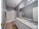 Bathroom with granite vanity, double sinks, tub/shower and neutral paint at 7642 Horseshoe Creek Dr, Huntersville, NC 28078