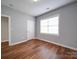 Bright bedroom with hardwood floors, neutral paint, and natural light at 7642 Horseshoe Creek Dr, Huntersville, NC 28078
