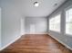 Spacious room with hardwood flooring, natural light, and neutral paint at 7642 Horseshoe Creek Dr, Huntersville, NC 28078