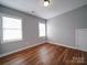 Bright bedroom with hardwood floors, neutral paint, and natural light at 7642 Horseshoe Creek Dr, Huntersville, NC 28078