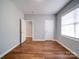 Bedroom with hardwood flooring, two closets, natural light, and neutral paint at 7642 Horseshoe Creek Dr, Huntersville, NC 28078