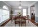 Well-lit dining room showcasing a chandelier, hardwood floors, and stainless steel refrigerator at 7642 Horseshoe Creek Dr, Huntersville, NC 28078
