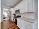 Modern kitchen with white cabinets, stainless steel appliances, granite countertops, and subway tile backsplash at 7642 Horseshoe Creek Dr, Huntersville, NC 28078