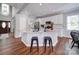 Spacious kitchen featuring a large island with seating, modern appliances, and hardwood floors at 7642 Horseshoe Creek Dr, Huntersville, NC 28078