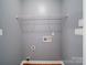 Clean laundry area with built in shelving and hardwood flooring at 7642 Horseshoe Creek Dr, Huntersville, NC 28078