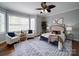 Inviting main bedroom suite showcasing a ceiling fan, neutral paint, stylish decor, and great natural light at 7642 Horseshoe Creek Dr, Huntersville, NC 28078