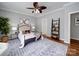 Light-filled main bedroom featuring a ceiling fan, hardwood floors, a neutral color palette, and sophisticated decor at 7642 Horseshoe Creek Dr, Huntersville, NC 28078