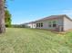 Wide backyard featuring a lush lawn and an exterior view of the home with vinyl siding at 7642 Porrera St, Charlotte, NC 28214