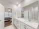 Bright bathroom with double vanity, quartz countertops, large mirror, and walk-in shower view at 7642 Porrera St, Charlotte, NC 28214
