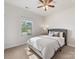 Bright bedroom with plush carpeting, large window, and a comfortable bed at 7642 Porrera St, Charlotte, NC 28214
