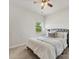 Bright bedroom with a ceiling fan, bed with pillows and blankets, and a window allowing natural light at 7642 Porrera St, Charlotte, NC 28214