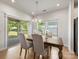 Bright dining area with hardwood floors, chandelier, and sliding glass doors to the backyard at 7642 Porrera St, Charlotte, NC 28214