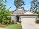 Charming single-story home with a two-car garage, landscaped front yard, and a welcoming entrance at 7642 Porrera St, Charlotte, NC 28214