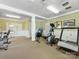 A community gym with exercise machines, carpeted floor, and plenty of space for working out at 7642 Porrera St, Charlotte, NC 28214