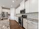 Well-equipped kitchen featuring stainless steel appliances, granite countertops, and white cabinetry at 7642 Porrera St, Charlotte, NC 28214