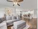 Open-concept living space with sofa, ottoman, and a view into the modern kitchen with bar seating at 7642 Porrera St, Charlotte, NC 28214