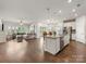 Spacious open-concept living area with kitchen island and a view to the outdoors at 7642 Porrera St, Charlotte, NC 28214