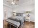 Main bedroom suite with tray ceiling, ceiling fan, hardwood floors, and a decorative bench at 7642 Porrera St, Charlotte, NC 28214