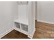 Functional mudroom with storage cubbies for shoes, hooks for coats, and durable hardwood flooring at 7642 Porrera St, Charlotte, NC 28214