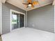 Covered patio with a ceiling fan, concrete flooring, and sliding glass doors to the indoors at 7642 Porrera St, Charlotte, NC 28214