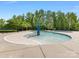 Shallow community pool area with playful water features and surrounded by mature trees at 7642 Porrera St, Charlotte, NC 28214