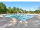 Large swimming pool with clear blue water, surrounded by green trees in a community space at 7642 Porrera St, Charlotte, NC 28214