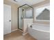 Modern bathroom features a white garden tub and a sleek, glass-enclosed shower at 79044 Ridgehaven Rd, Lancaster, SC 29720