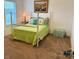 Well-lit bedroom with a bed featuring a bright green comforter and lots of light at 79044 Ridgehaven Rd, Lancaster, SC 29720