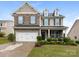 Charming two-story home featuring a stone facade, manicured landscaping, and an attached two-car garage at 79044 Ridgehaven Rd, Lancaster, SC 29720