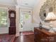 Elegant foyer featuring hardwood floors, a grandfather clock, and a decorative mirror at 79044 Ridgehaven Rd, Lancaster, SC 29720