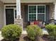 Charming home exterior with stone accents, manicured bushes and a lovely front porch seating area at 79044 Ridgehaven Rd, Lancaster, SC 29720