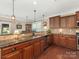 Spacious kitchen featuring a breakfast bar, granite countertops, and wooden cabinets at 79044 Ridgehaven Rd, Lancaster, SC 29720