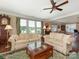 Bright living room features two sofas, large windows and an elegant ceiling fan at 79044 Ridgehaven Rd, Lancaster, SC 29720