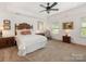 Bright bedroom with trey ceiling, neutral carpet, a decorative bed and plenty of natural light at 79044 Ridgehaven Rd, Lancaster, SC 29720