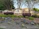 Walnut Creek neighborhood entrance with stone walls, lush landscaping, and colorful flowerbeds at 79044 Ridgehaven Rd, Lancaster, SC 29720