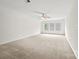 Spacious bedroom with plush carpet, ceiling fan and lots of natural light from a large window at 8120 Calistoga Ln, Waxhaw, NC 28173