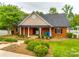 Attractive brick clubhouse featuring a gable roof, manicured landscaping, and columned entry at 8120 Calistoga Ln, Waxhaw, NC 28173