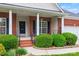 Inviting front porch with brick columns and decorative iron railings at 8120 Calistoga Ln, Waxhaw, NC 28173